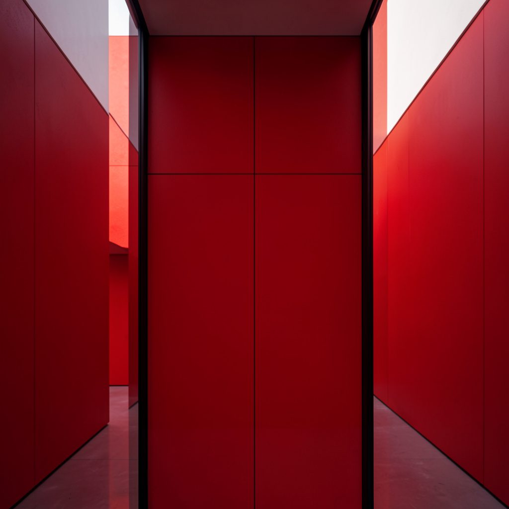 A warmly lit conference hall with rows of attentive attendees, deep navy and burgundy accents echoing the brand palette, conveying community and shared purpose.